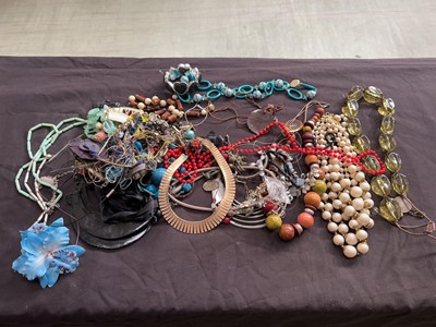 Lot 404 - A tin containing an assortment of costume...