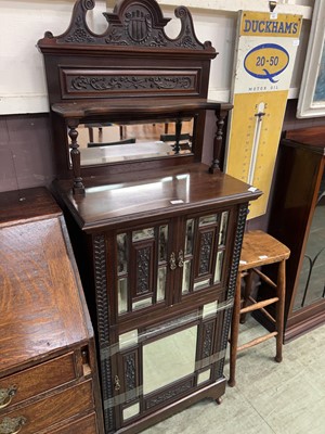Lot 61 - A carved mahogany cupboard with shelf to top...