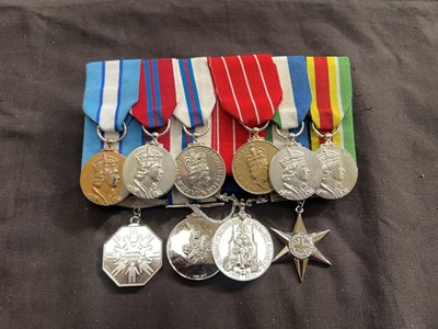 Lot 408 - A bag containing an assortment of military...