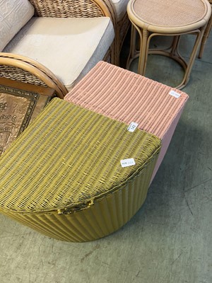 Lot 142 - A pink Lloyd Loom laundry hamper along with...