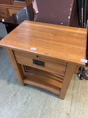 Lot 143 - A modern oak side table with drawer over open...