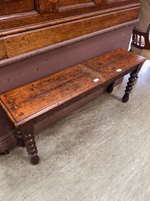 Lot 45 - An early 20th century oak carved bench on...