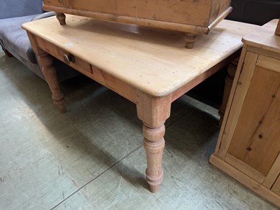 Lot 91 - A farmhouse-style pine kitchen table with...