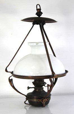 Lot 66 - A copper-finished ceiling-hung oil lamp in the...