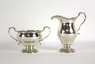 Lot 245 - A silver milk jug on raised foot together with...