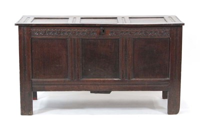 Lot 13 - An 18th century oak panelled coffer, the lid...