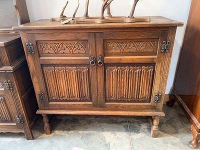 Lot 1005 - Dark oak linen fold double door cupboard