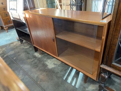 Lot 1029 - Mid Century teak bookcase with glazed sliding...