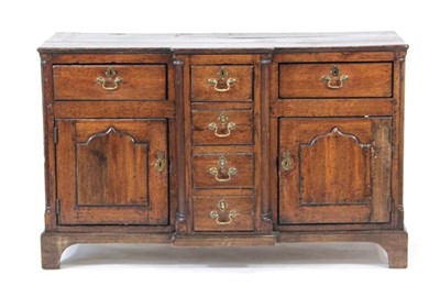 Lot 18 - A George II/III oak breakfront dresser, the...