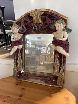 Lot 1115 - Highly ornate wall mirror in a cherub adorned...