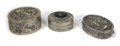 Lot 224 - An oval silver pill box repousse decorated...