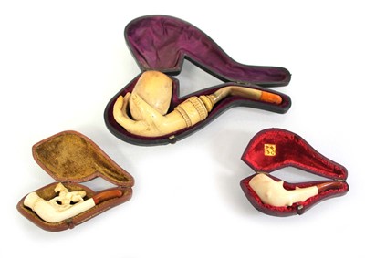 Lot 84 - A group of three cased Meerschaum and amber...