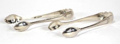 Lot 234 - Two pairs of matching silver sugar nips,...