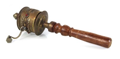Lot 93 - A South East Asian brass-finished prayer wheel...