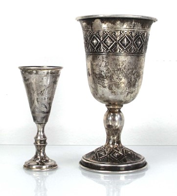 Lot 276 - A metalware and parcel gilt goblet decorated...