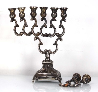 Lot 277 - A metalware menorah of typical form decorated...