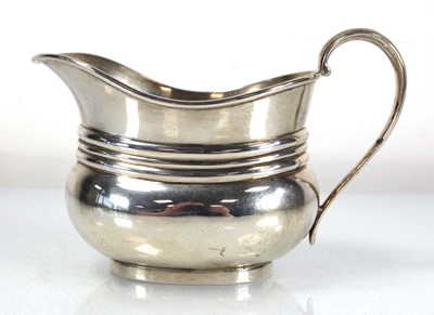 Lot 290 - A silver milk jug of boat shaped form,...