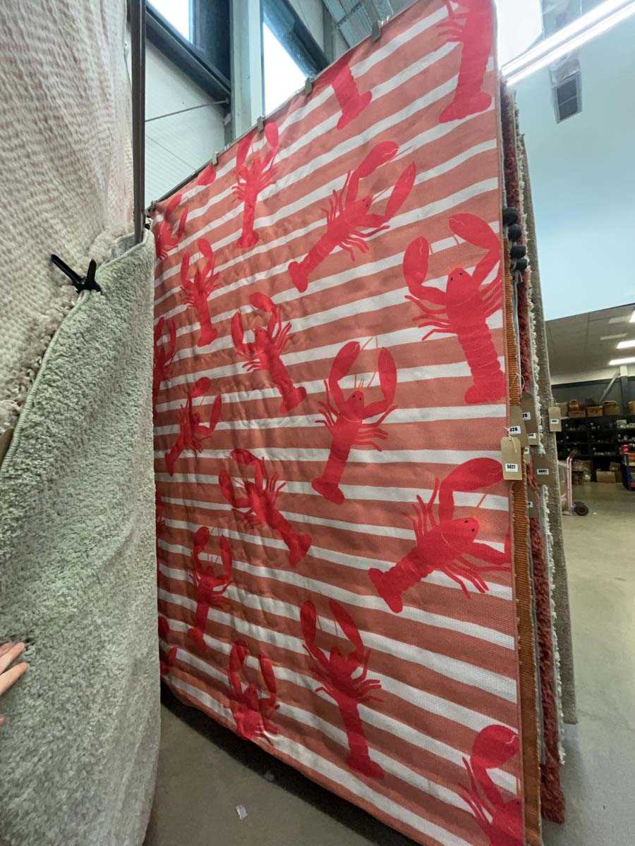 Lot 5027 - Large red striped rug with lobster decoration