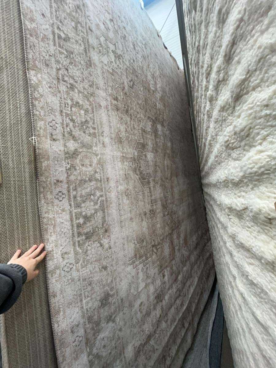 Lot 5053 - Large modern rug in beige and faded green