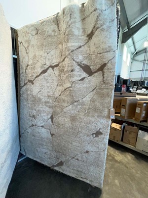 Lot 1314 - Patterned white and brown area rug, approx....