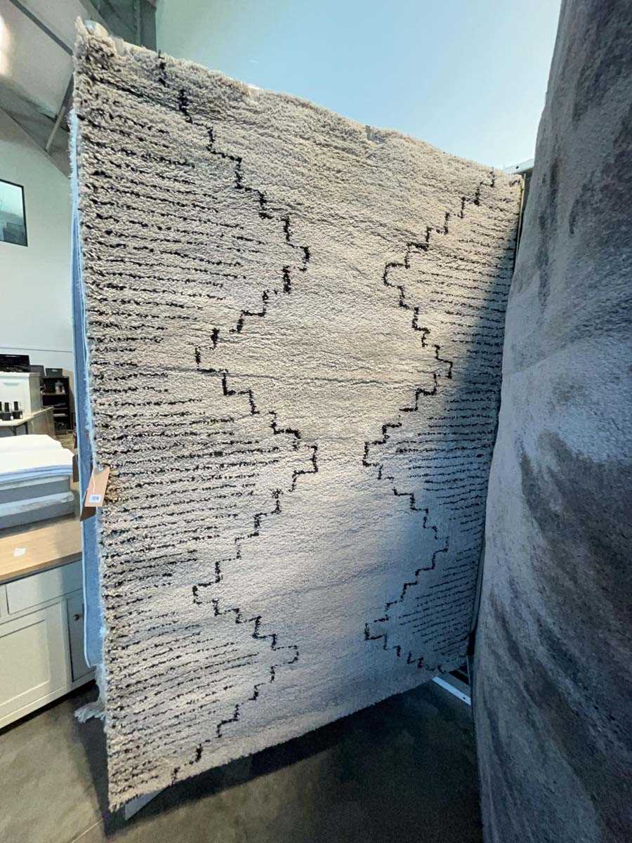 Lot 1319 - Striped black and white area rug with central...