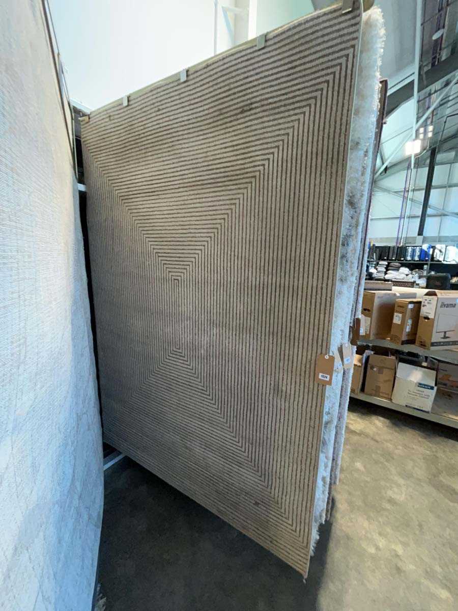 Lot 1324 - Textured beige and brown patterned area rug,...