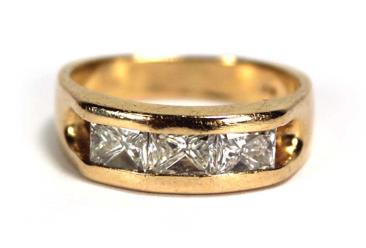 Lot 699 - A 14ct yellow gold ring set three princess cut...