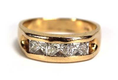 Lot 699 - A 14ct yellow gold ring set three princess cut...