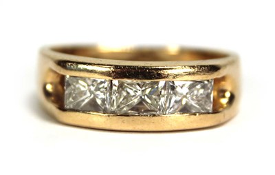 Lot 699 - A 14ct yellow gold ring set three princess cut...