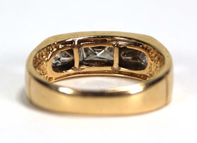 Lot 699 - A 14ct yellow gold ring set three princess cut...