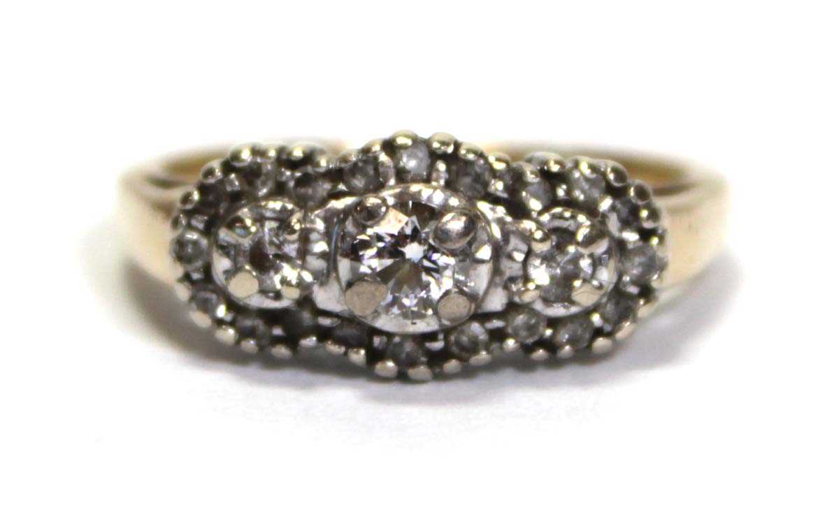 Lot 700 - A 14ct yellow gold ring set small diamonds in...