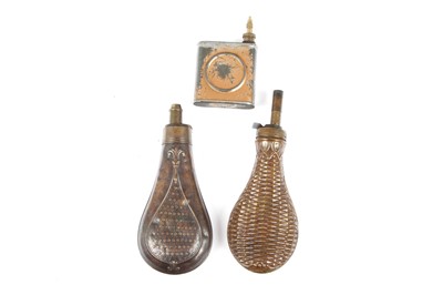 Lot 14 - Two copper and brass powder flasks, with a...