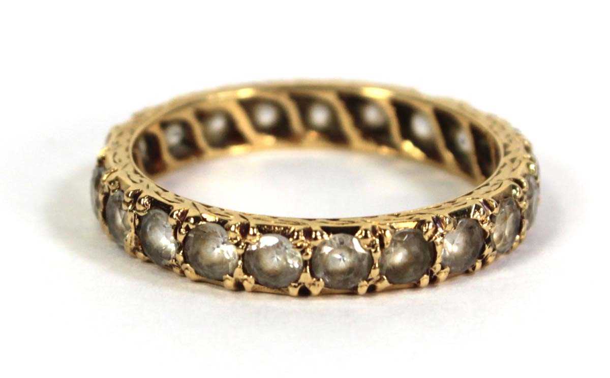Lot 506 - A yellow metal full eternity ring set paste,...