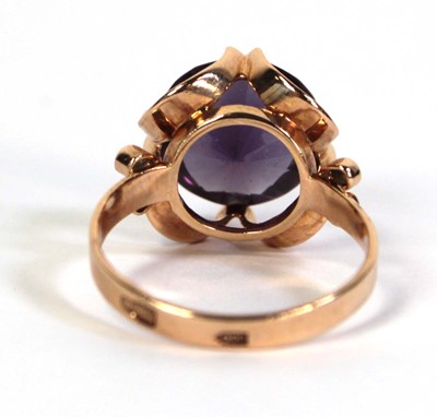 Lot 511 - A 14ct yellow gold ring set circular purple...
