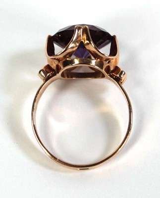 Lot 511 - A 14ct yellow gold ring set circular purple...