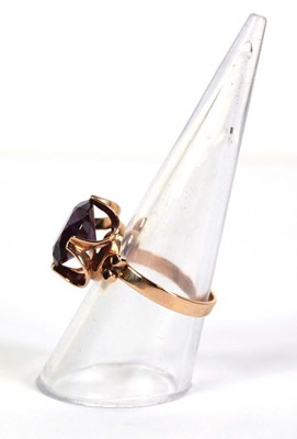 Lot 511 - A 14ct yellow gold ring set circular purple...