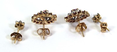 Lot 512 - A pair of 9ct yellow gold ear studs, each set...