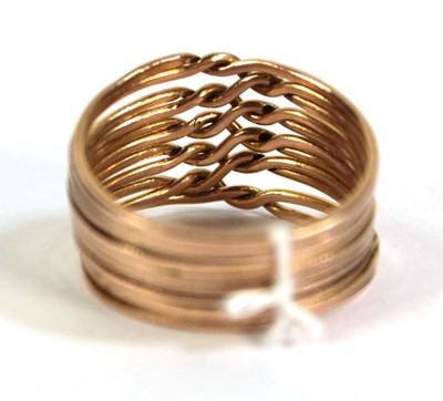 Lot 518 - A yellow metal eleven section puzzle ring,...