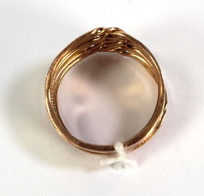 Lot 518 - A yellow metal eleven section puzzle ring,...