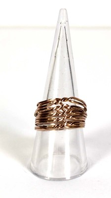 Lot 518 - A yellow metal eleven section puzzle ring,...