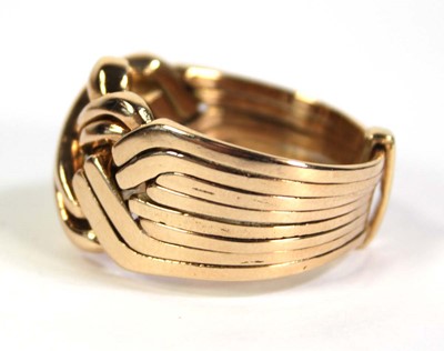 Lot 519 - A yellow metal eight section puzzle ring, ring...