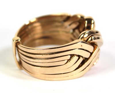Lot 519 - A yellow metal eight section puzzle ring, ring...